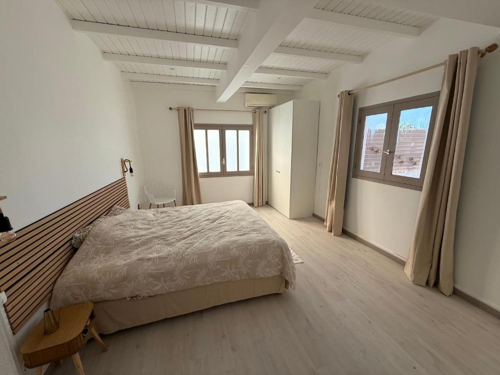 a bedroom with a large bed and a large window at Villa Mamina Martinique in Fort-de-France