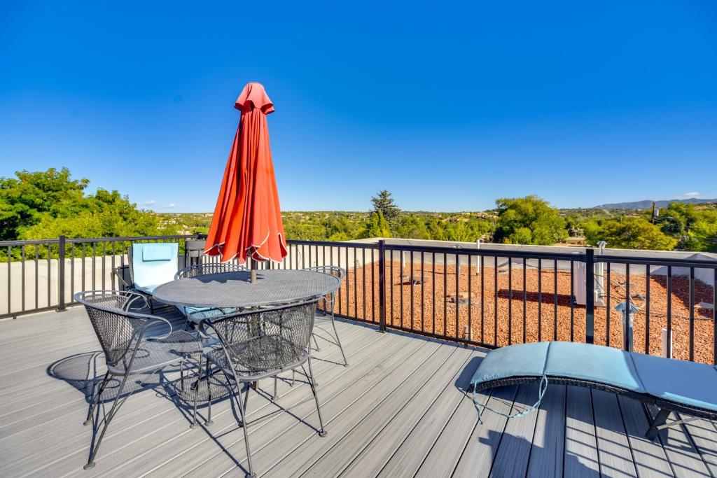 a patio with a table and an umbrella on a deck at Less Than 1 Mi to Santa Fe Plaza Mtn-View Gem with Hot Tub! in Santa Fe