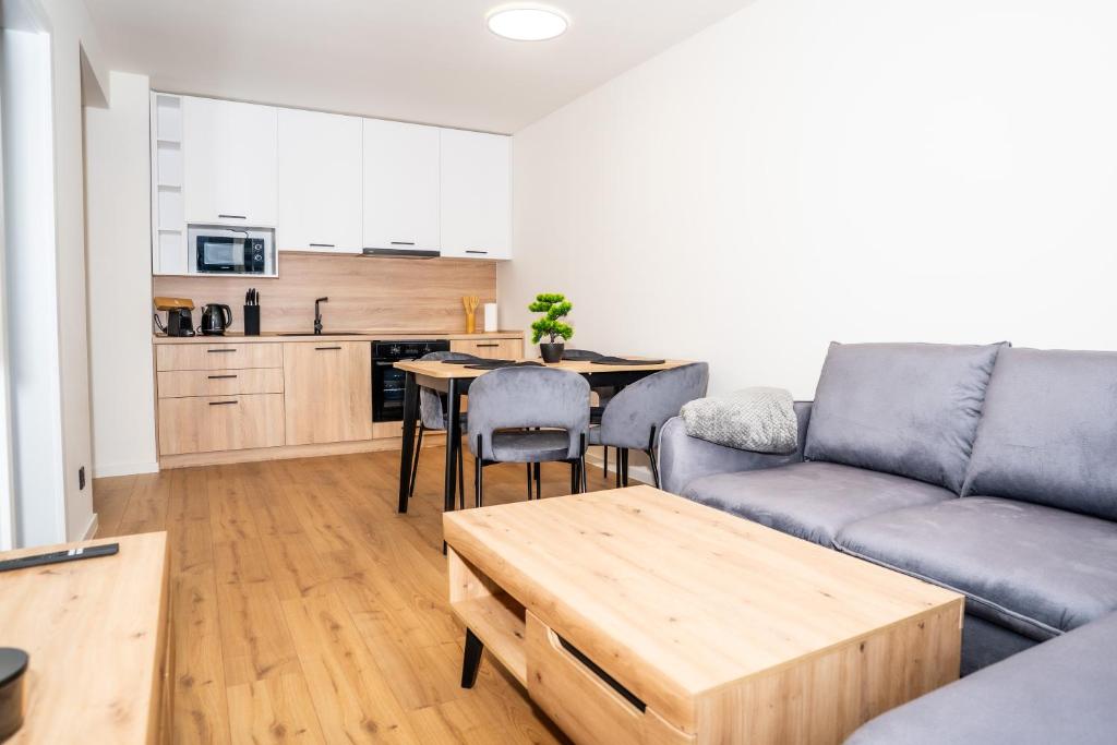 a living room with a couch and a table at Luxapartment l Krivá in Košice