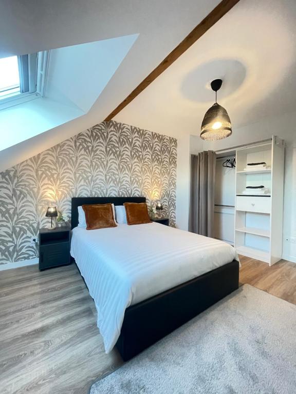 Ένα ή περισσότερα κρεβάτια σε δωμάτιο στο La Maison du Vignoble