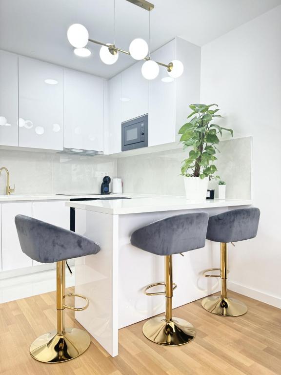 a kitchen with a counter and two bar stools at Apartman Lilly - Zagreb - Mirna Lokacija - Lođa in Zagreb