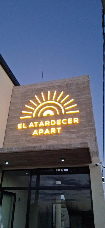 a sign on the front of a department store at El Atardecer Apart in Federación