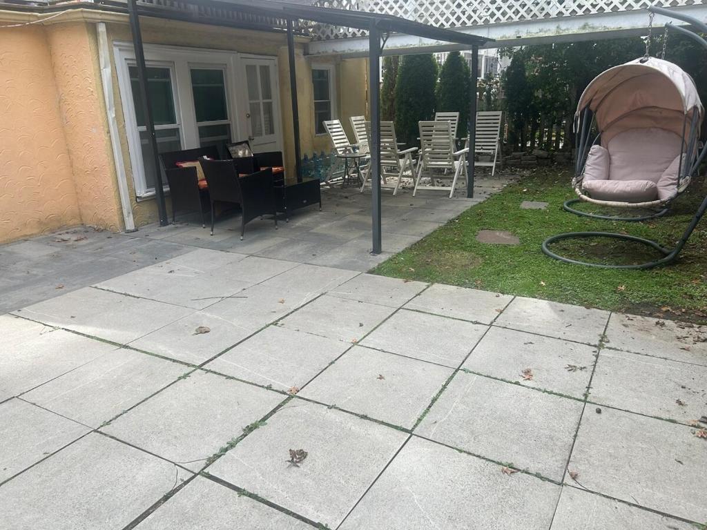 a patio with a tent and a table and chairs at Guest Suite - 21 mins to New York City - 6 guests in Yonkers