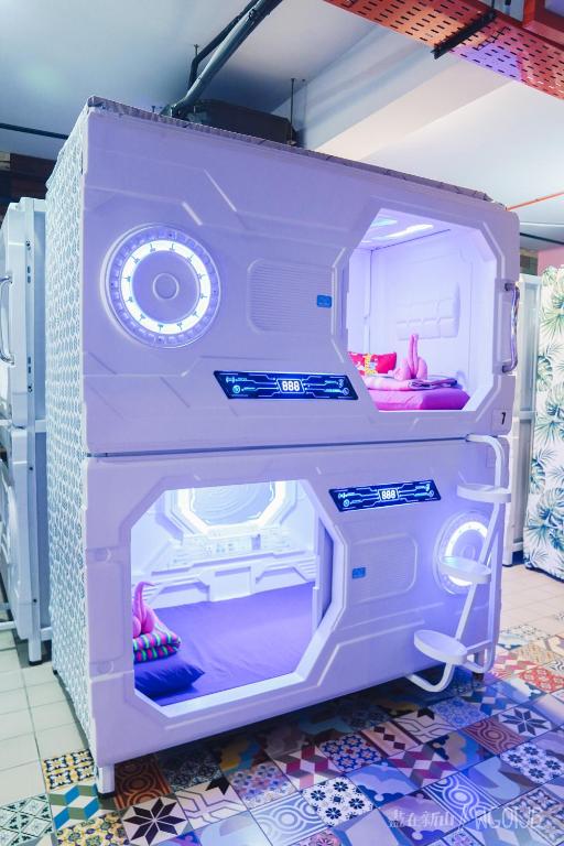 a toy refrigerator with its door open on a floor at ZZZ Sleep Mode Capsules- Larkin in Johor Bahru