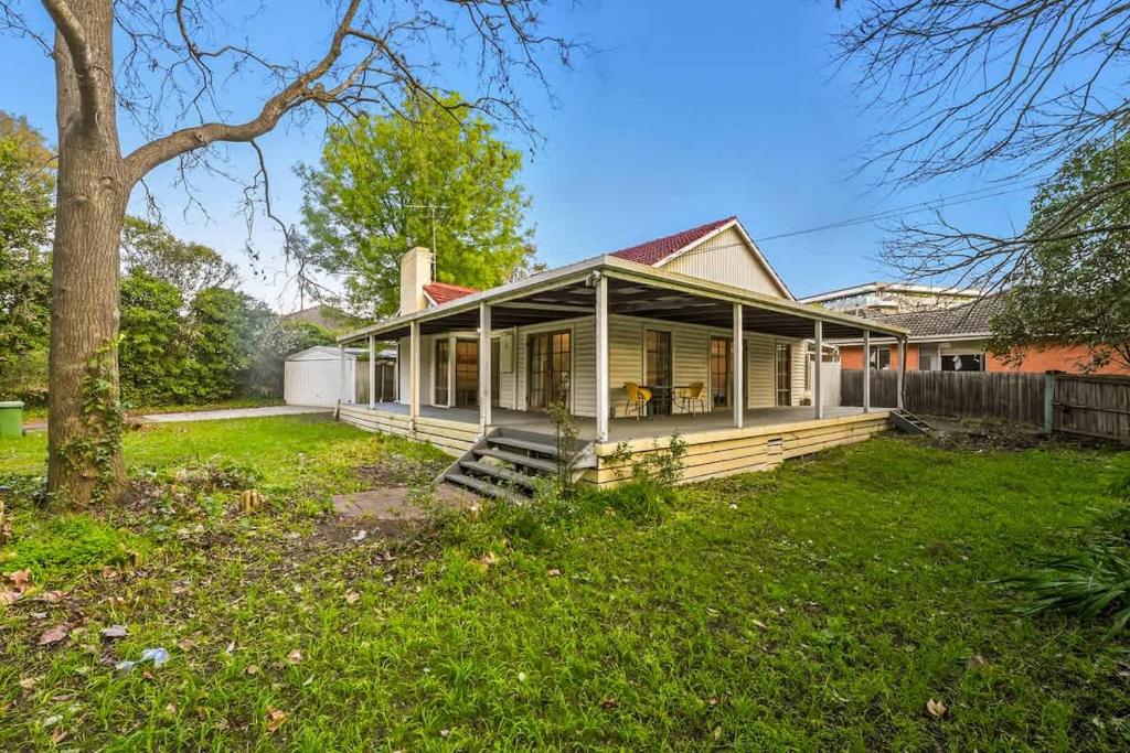 a home with a porch and green grass at Relaxing Ringwood Getaway near Mullum Mullum Trail in Ringwood