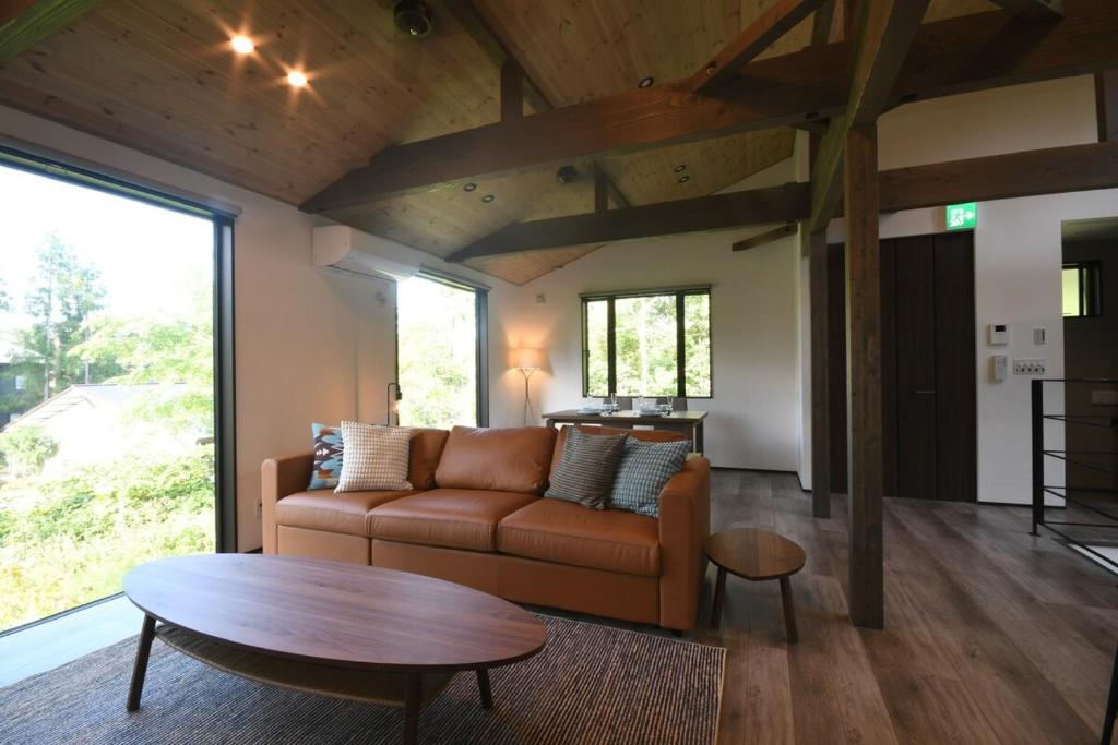 un soggiorno con un divano e un tavolo di Greyton A - Brand new chic bright spacious 2BR a Wada