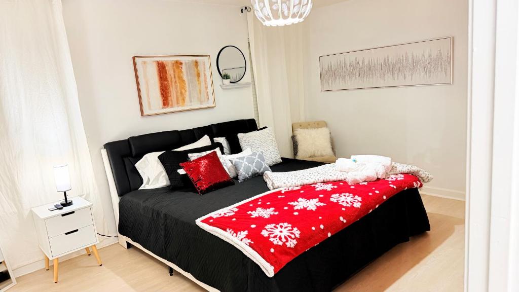 a bedroom with a bed with a red blanket at Christmas 3BR , King and Queen Beds , Uptown Charlotte in Charlotte