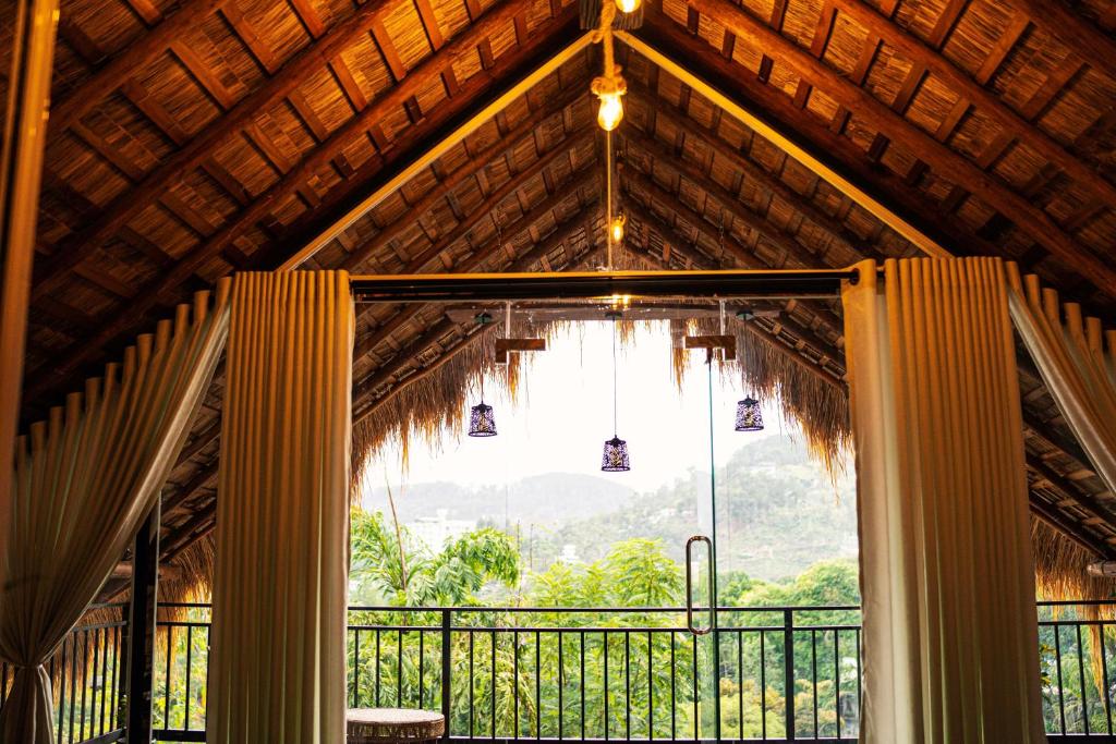 a room with a large window and a chandelier at Cliff Edge Villa in Ella