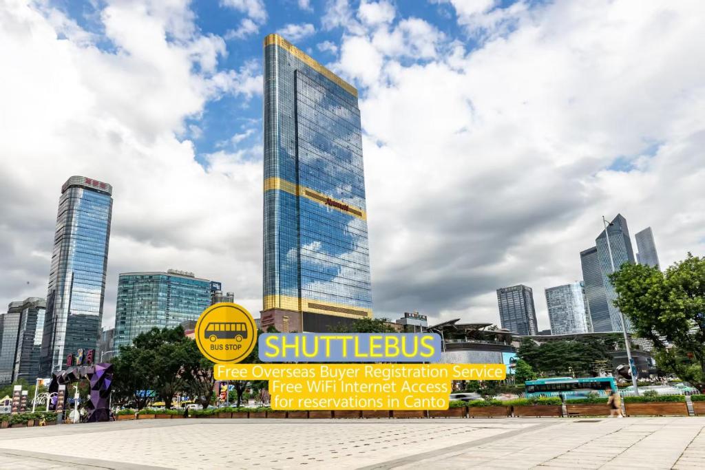 a tall building with a sign in front of a city at WAIFIDEN Guangzhou Grand View Golden Palace Apartment in Guangzhou