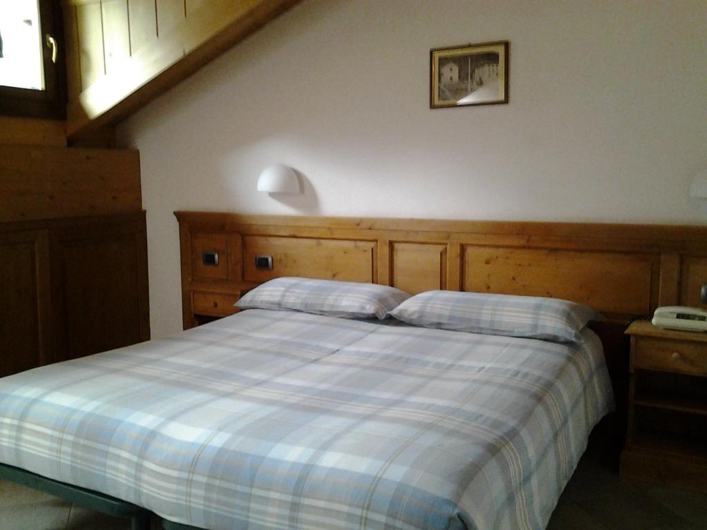 Postel nebo postele na pokoji v ubytování Hotel Compagnoni