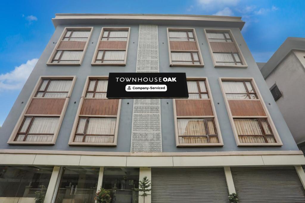 a building with a sign in front of it at Super Townhouse Oak Sevoke Road Siliguri in Siliguri
