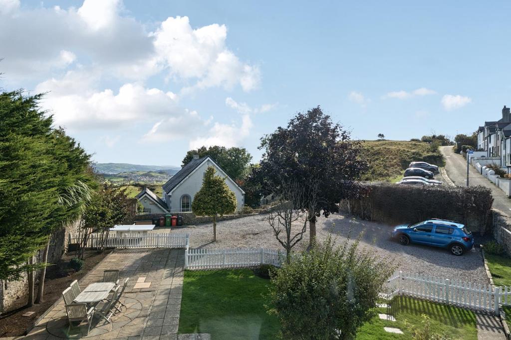 a house with a car parked in a parking lot at Ty Mawr, Great Orme in Llandudno