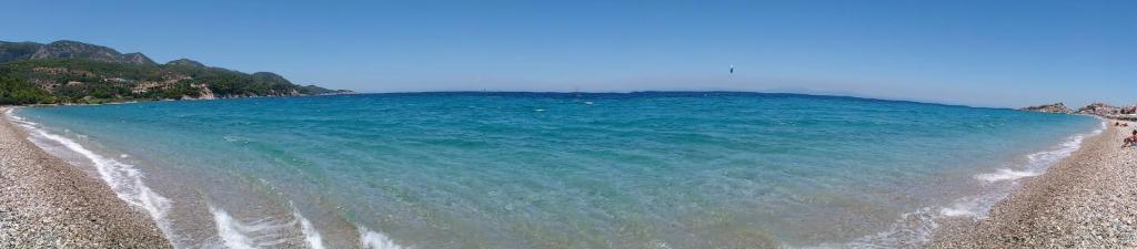 a view of a beach with blue water at Kate Apartments in Kokkari