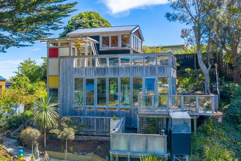 a large house with a lot of glass windows at The Paint Box in Raumati South