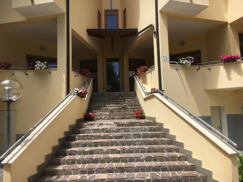 a set of stairs leading up to a building at Appartamento sirente in Rovere