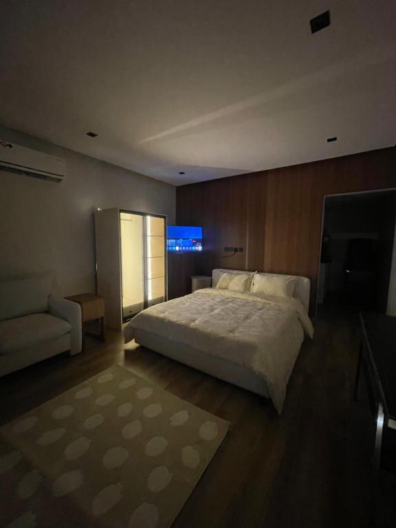 a bedroom with a large bed and a television at Aurum studio in Riyadh