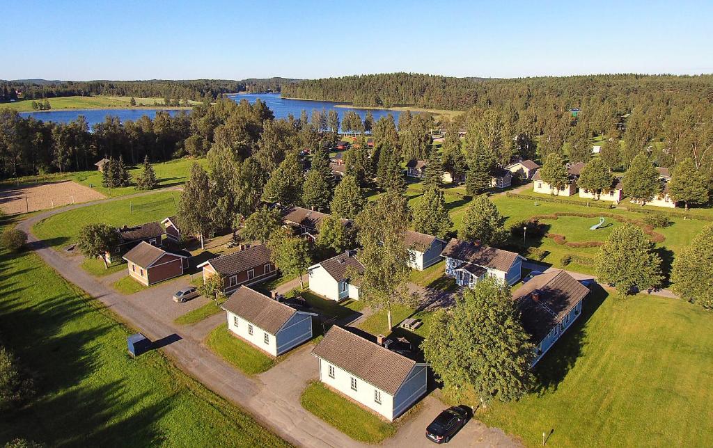 an aerial view of a village with a house and a lake at Visulahti Cottages in Mikkeli