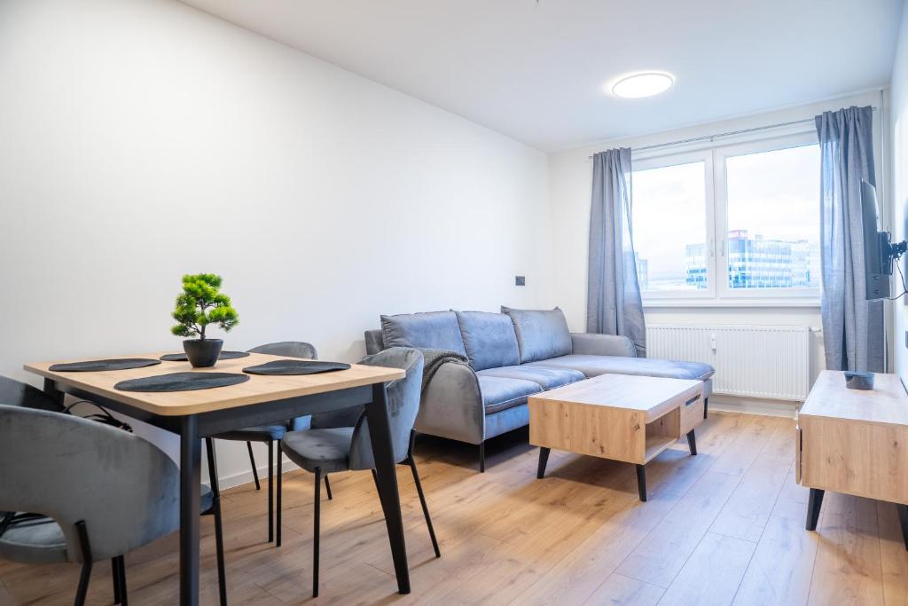 a living room with a blue couch and a table at Luxapartment ll Krivá in Košice