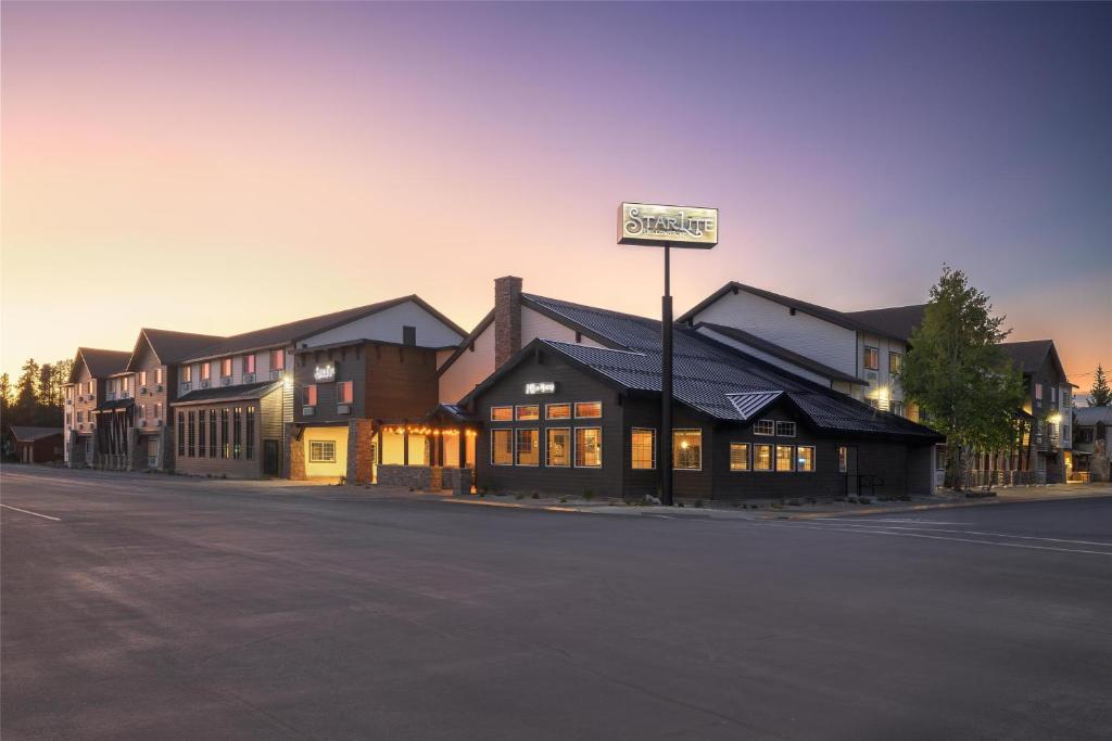 a building with a street sign on the side of a street at Starlite Yellowstone, Tapestry Collection by Hilton in West Yellowstone