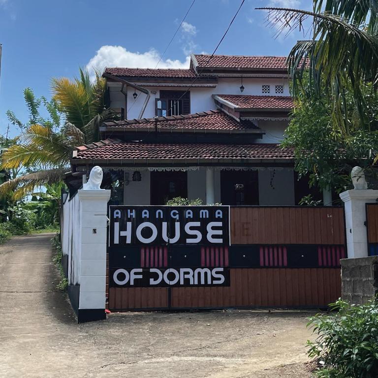 a house with a sign that reads house of dominos at House of Dorms in Ahangama
