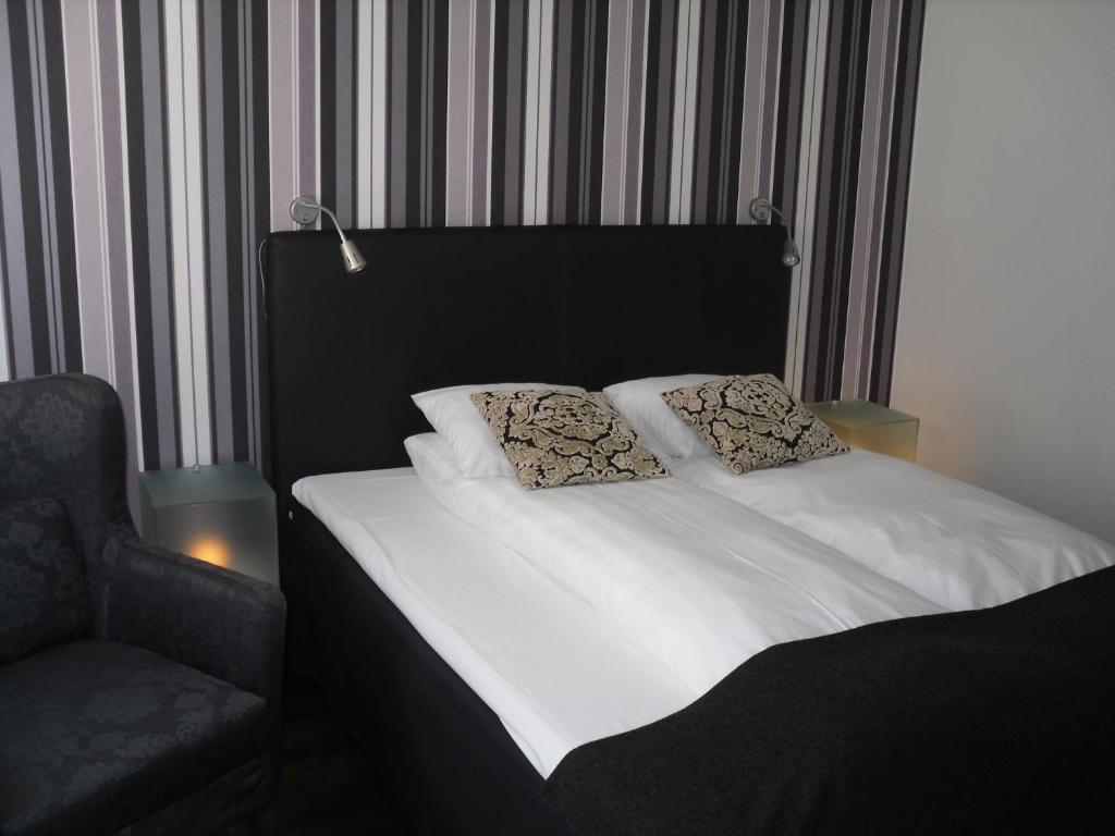 Postel nebo postele na pokoji v ubytování First Hotel Witt