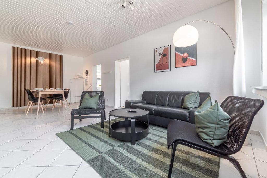 a living room with a couch and a table at M3 Workers Home in Bocholt