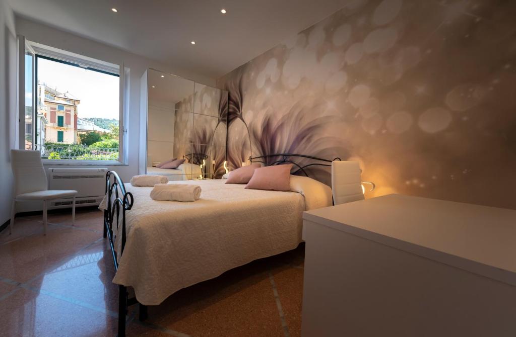 a bedroom with a bed with a painting on the wall at La rosa dei venti in Santa Margherita Ligure