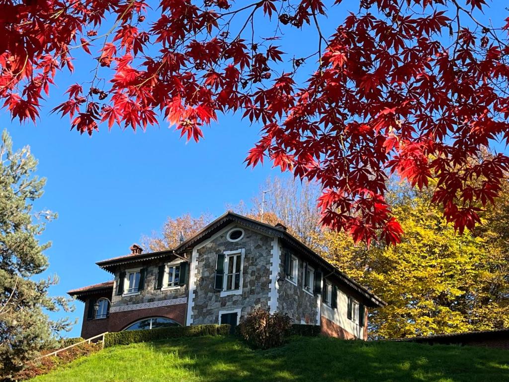 an old stone house on a hill with autumn leaves at L'Elefante Fritz Boutique Lodge - Villa Piazzo in Pettinengo