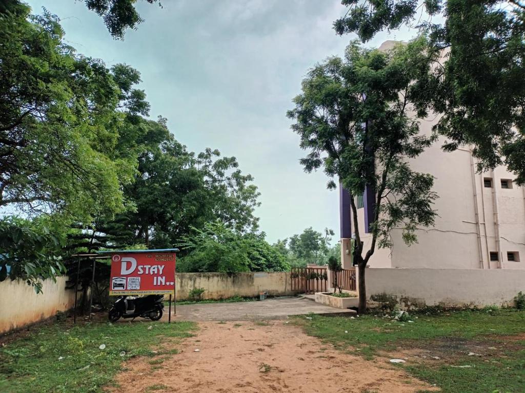 a sign in front of a building with a driveway at Dstay in in Visakhapatnam