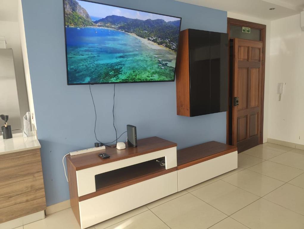 a living room with a tv on a wall at 4 Double Bedroom With Terrace in the centre of Sliema in Sliema