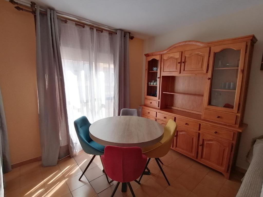 a kitchen with a table and chairs and a cabinet at Apartamento para 6 personas en Barbastro in Barbastro