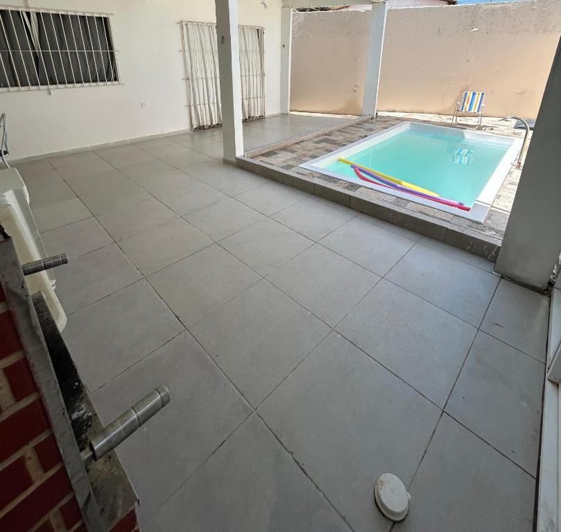 a room with a swimming pool and a tile floor at Casa na Ilha de Itamaraca in Vila Velha