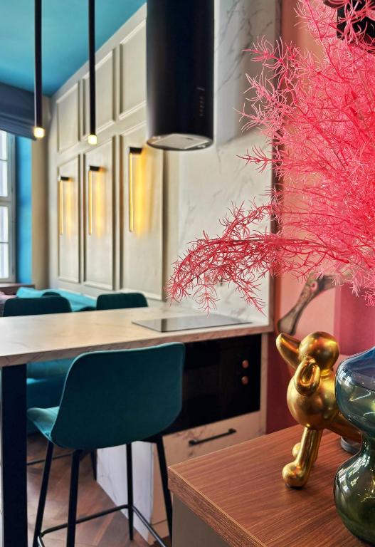a kitchen with a table and a vase on a table at 8 - Il Becco Rosato - DonViore in Győr