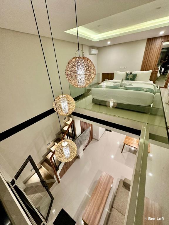 a bedroom with a bed and a glass floor at Matra Apartment in Canggu