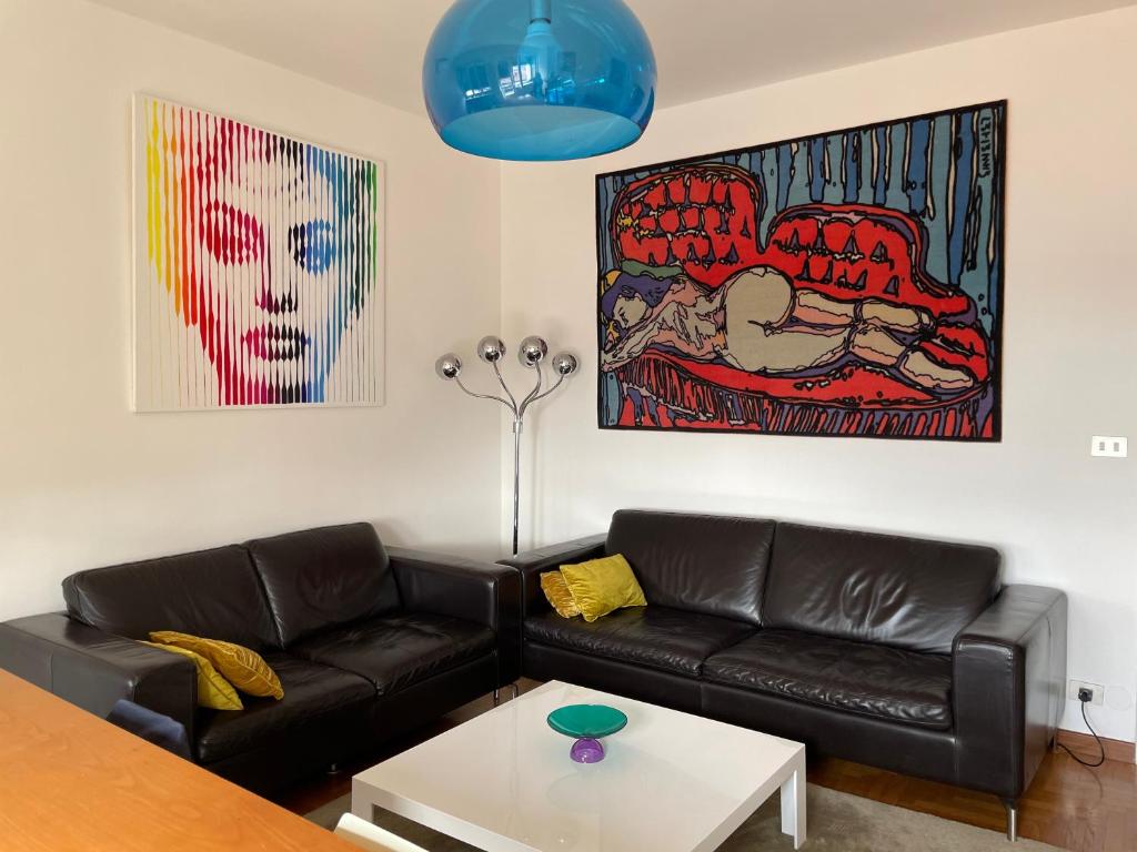 a living room with a couch and a table at Olivrea Design Palazzo in Ivrea