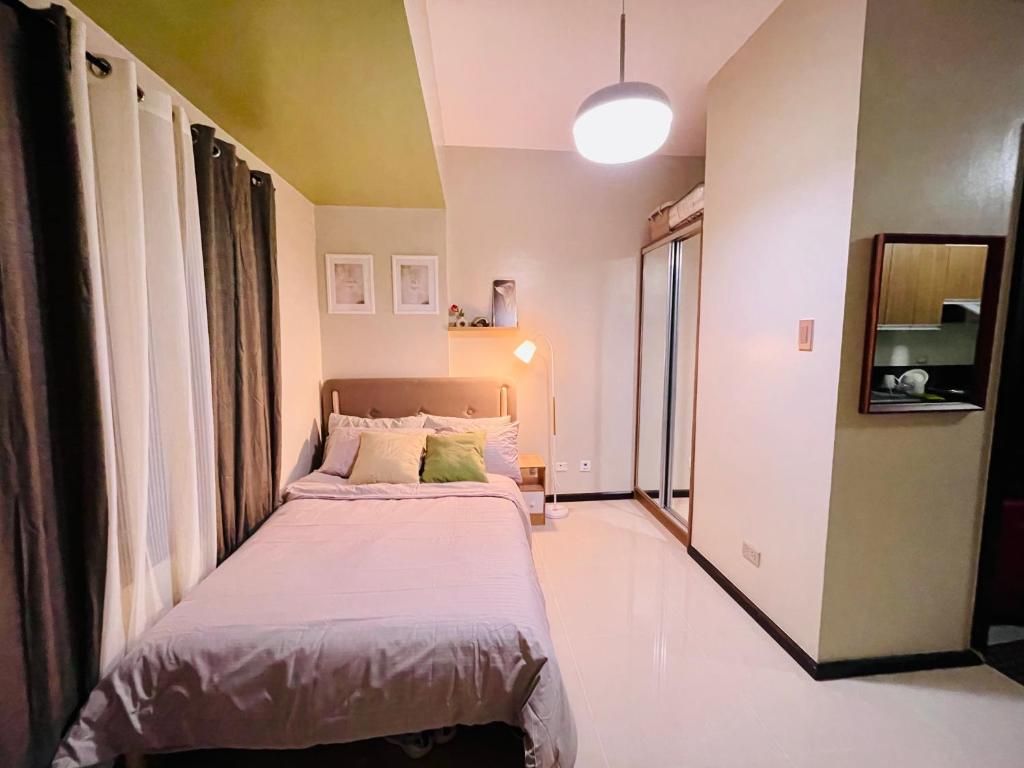 a small bedroom with a bed in a room at Urbanstay at The Radiance Manila Bay in Manila