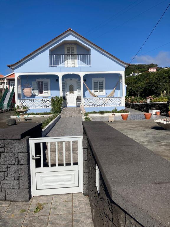 a house with a white fence in front of it at Casa da Baía da Manhenha in Manhenha