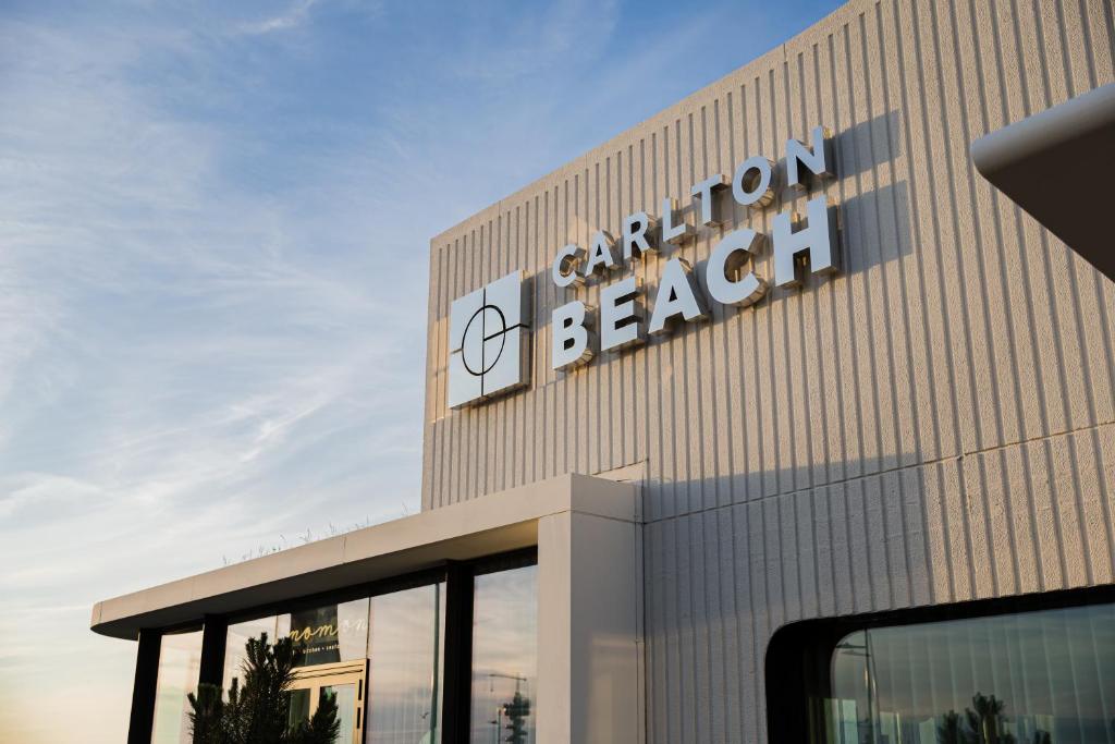 a building with a sign on the side of it at Carlton Beach in Scheveningen