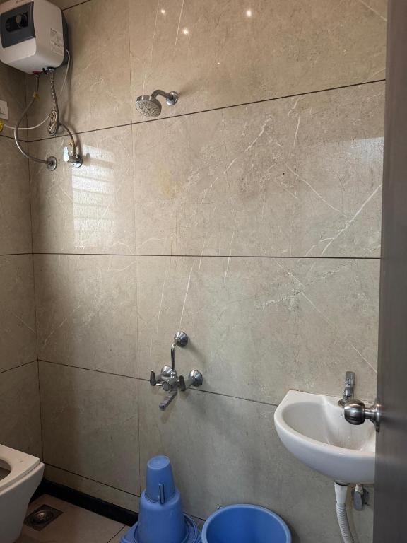 a bathroom with a sink and a toilet at Shri Mahalaxmi Excative yatri nivas in Kolhapur