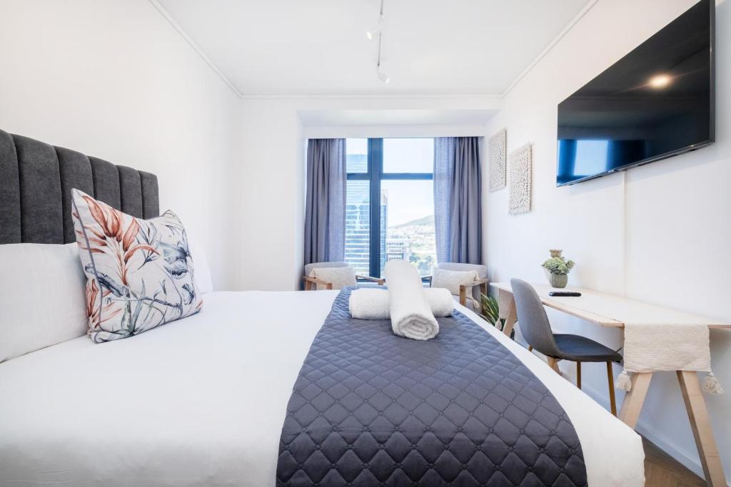 a hotel room with a bed and a desk at 1007 Zeeland - Top Floor Stylish Studio Near CTICC in Cape Town