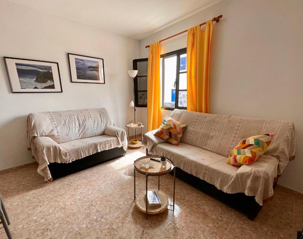 a living room with a couch and a chair at Apartamento Brisa Mar in Famara