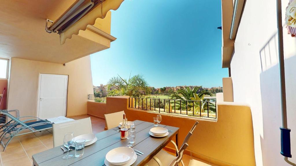 a dining room with a table and chairs and a balcony at Ginkgo 302891-A Murcia Holiday Rentals Property in Los Martínez