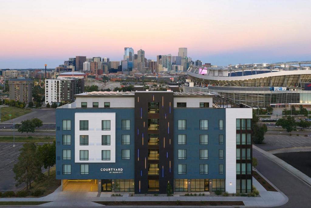 a rendering of a building with a city in the background at Courtyard by Marriott Denver Downtown West in Denver