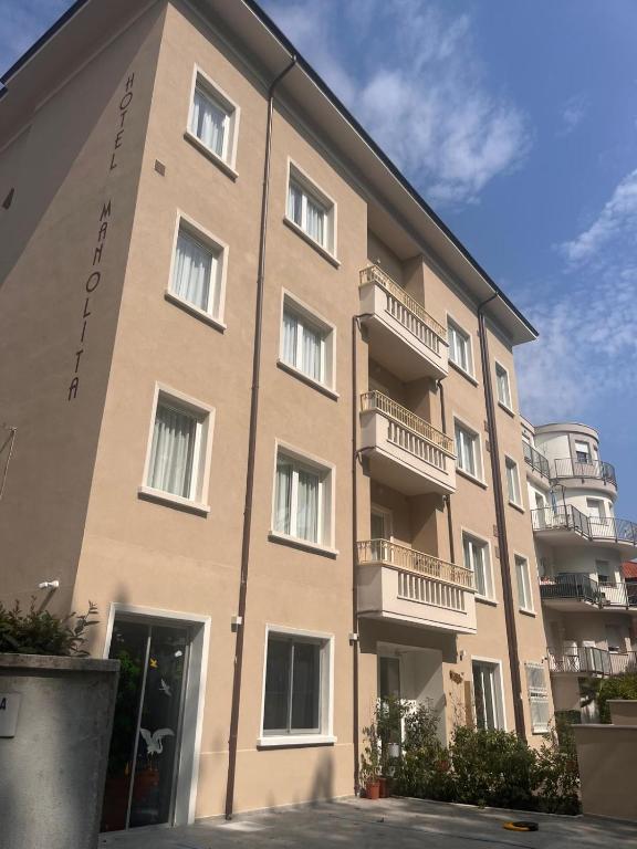 a large building with balconies on the side of it at Aparthotel Manolita in Rimini