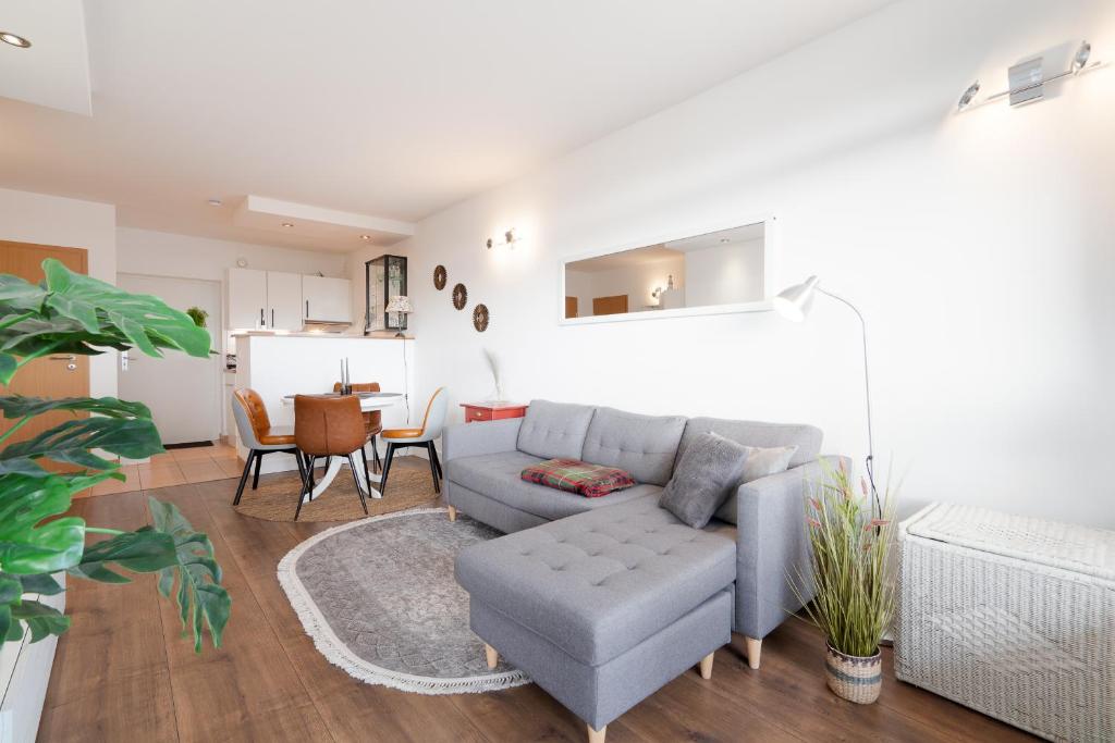 a living room with a couch and a table at Panoramic B03-1 in Sierksdorf