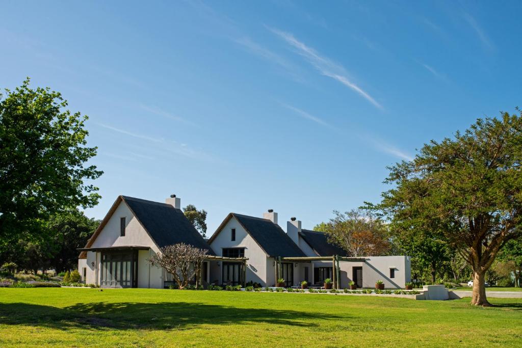 a large white house with black roof at Grace House in Robertson