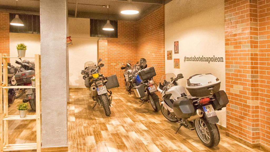 a row of motorcycles parked in a garage at Hotel Napoleon Susa in Susa