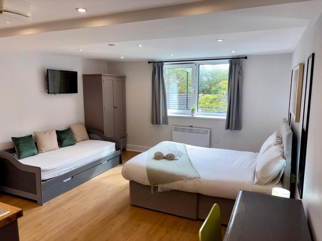 a small bedroom with a bed and a couch at City Apartments Newcastle in Newcastle upon Tyne