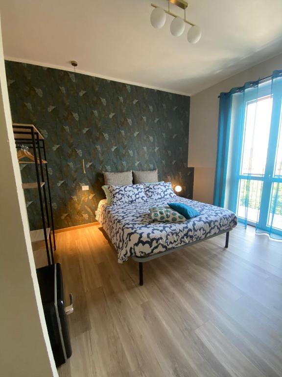 a bedroom with a bed in a room at Room&Go Alba - Home Langhe in Alba