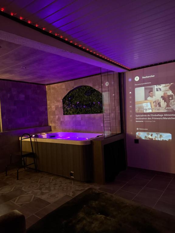 a stage with purple lights in a room at Secret Factory & Spa in Soultz-Haut-Rhin